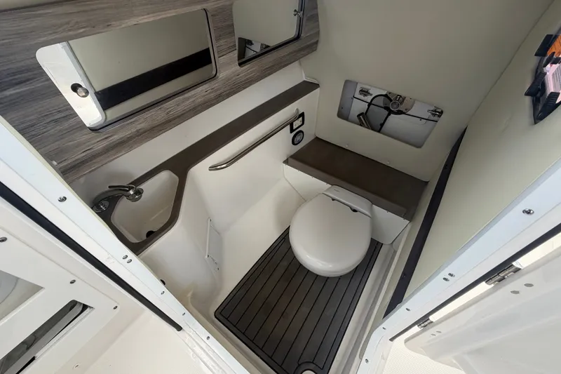 Slide: The Image of 2023 Edgewater 248CX Crossover boat bathroom with toilet, sink, and mirror. - 31
