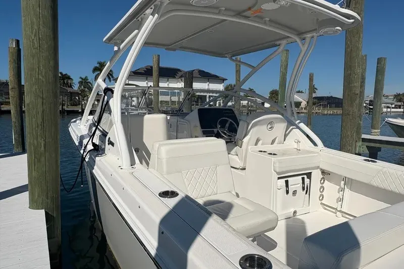 Slide: The Image of 2023 Edgewater 248CX Crossover boat docked, featuring spacious seating and sleek design. - 32