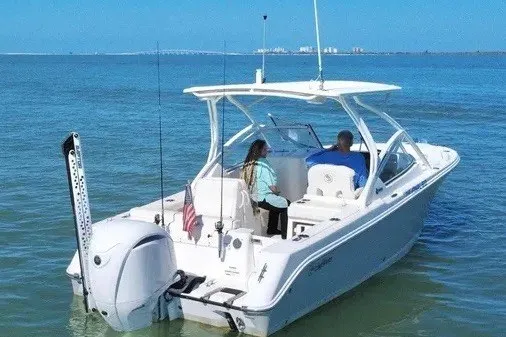 Slide: The Image of 2023 Edgewater 248CX Crossover boat cruising on calm blue waters. - 6