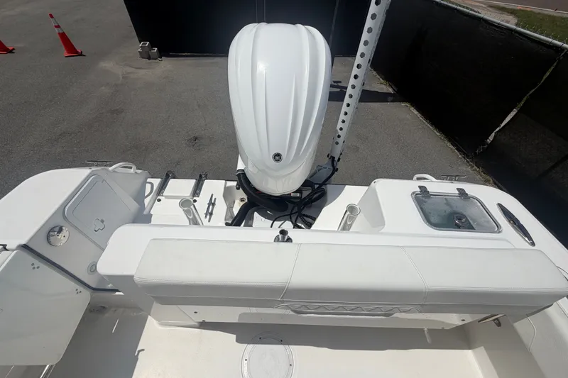 Slide: The Image of 2023 Edgewater 248CX Crossover boat with outboard motor and seating area. - 83