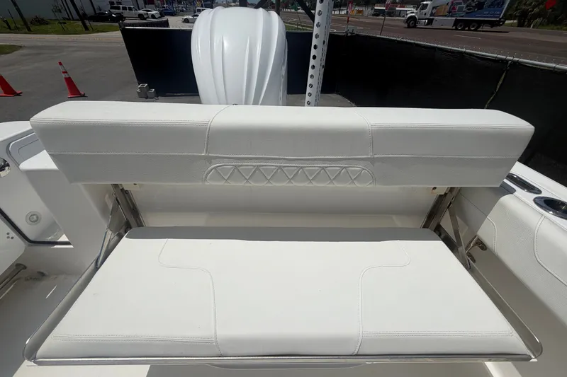 Slide: The Image of 2023 Edgewater 248CX Crossover boat seat with white upholstery and adjustable backrest. - 81