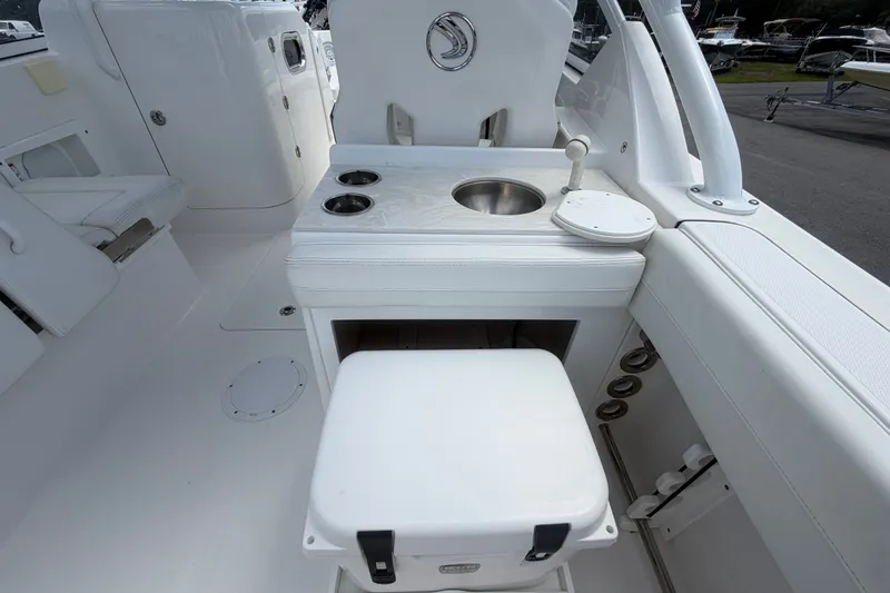 Slide: The Image of 2023 Edgewater 248CX Crossover boat interior with sink and seating area. - 19