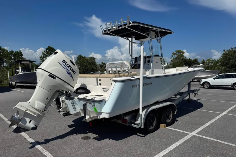 Slide: The Image of 2017 Sea Born LX22 Center Console boat with Suzuki outboard motor on trailer. - 2