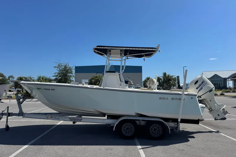 Slide: The Image of 2017 Sea Born LX22 Center Console boat on trailer, parked in sunny lot. - 6