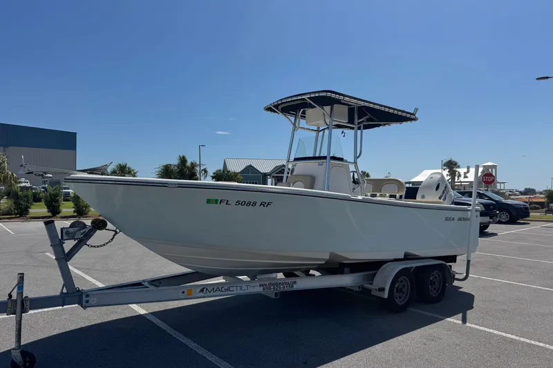 Slide: The Image of 2017 Sea Born LX22 Center Console boat on trailer in parking lot. - 5