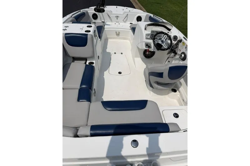 Slide: The Image of Interior of a 2017 Tahoe 1950 boat with blue and white seating. - 9