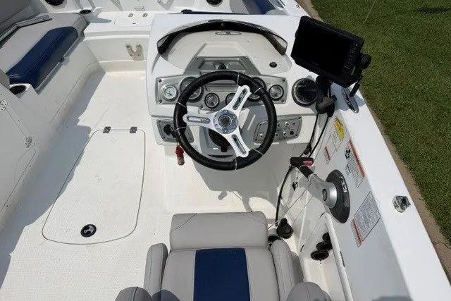 Slide: The Image of Cockpit of a 2017 Tahoe 1950 boat with steering wheel and control panel. - 12