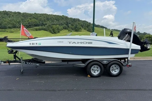 The Image of 2017 Tahoe 1950 boat on trailer, parked outdoors with scenic background. - 0
