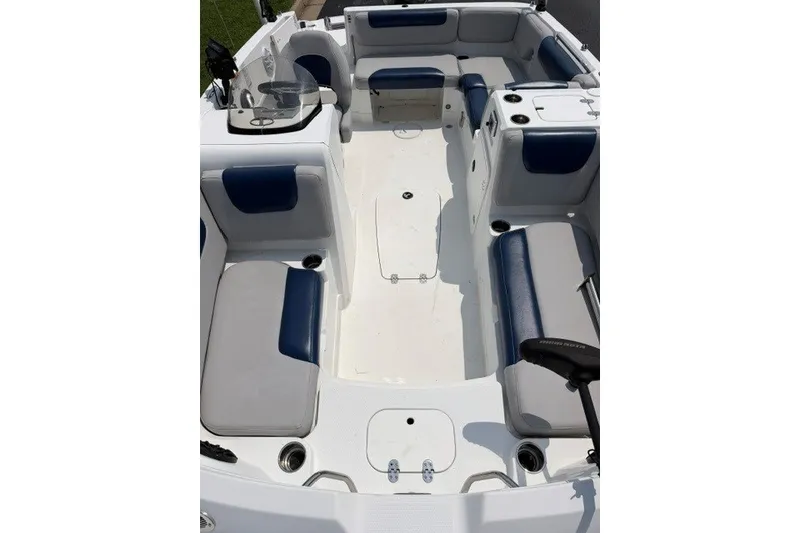 Slide: The Image of 2017 Tahoe 1950 boat interior with blue and gray seating, spacious layout. - 13