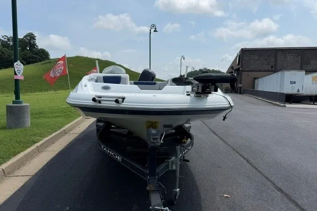 Slide: The Image of Front view of a 2017 Tahoe 1950 boat on a trailer in a parking lot. - 6