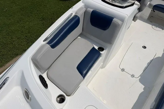 Slide: The Image of 2017 Tahoe 1950 boat interior with blue and gray seating, cup holders, and storage compartments. - 16
