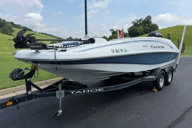Slide: The Image of Tahoe 1950 boat on trailer, 2017 model, parked on asphalt near grassy hills. - 7