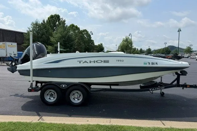 Slide: The Image of 2017 Tahoe 1950 boat on trailer in parking lot, sunny day. - 5