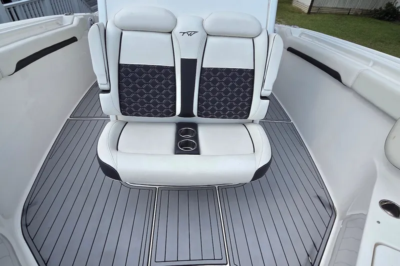 Slide: The Image of 2022 Tidewater 282 CC Adventure boat interior with cushioned seating and cup holders. - 13