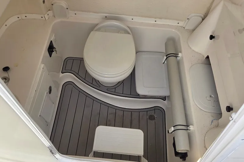 Slide: The Image of 2022 Tidewater 282 CC Adventure boat bathroom with toilet and storage compartments. - 20