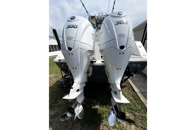 Slide: The Image of 2022 Tidewater 282 CC Adventure boat with dual 300 horsepower outboard engines. - 1