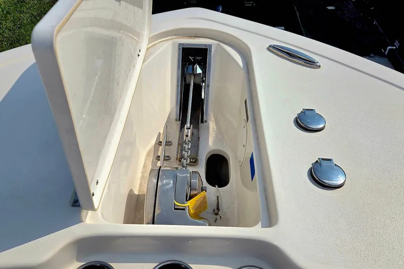 Slide: The Image of Anchor compartment of 2022 Tidewater 282 CC Adventure boat, showcasing storage and chain mechanism. - 19