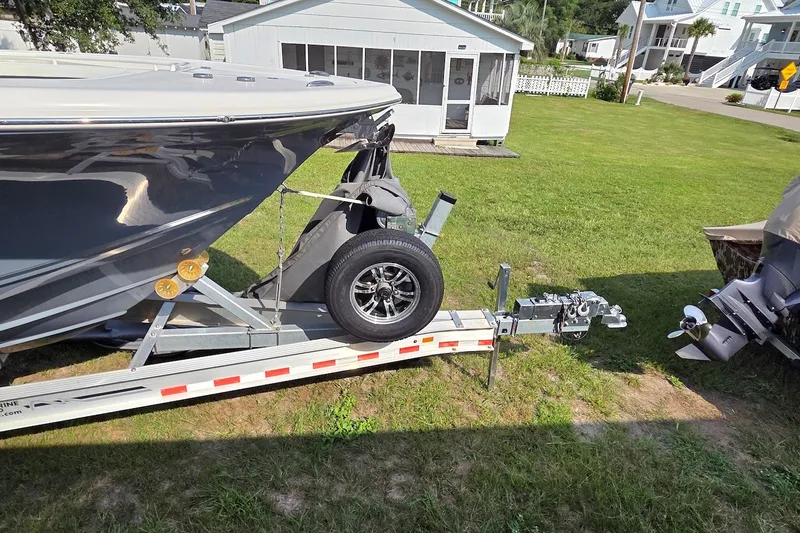 Slide: The Image of 2022 Tidewater 282 CC Adventure boat on trailer in residential yard. - 25