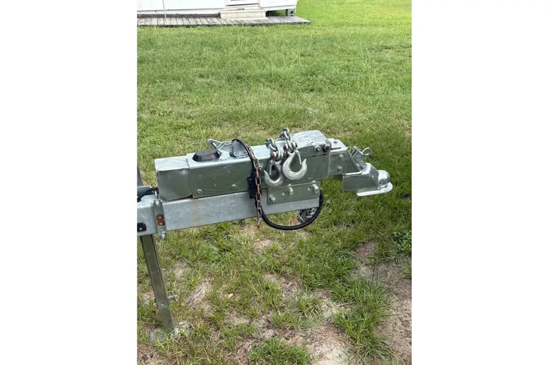 Slide: The Image of Trailer hitch of a 2022 Tidewater 282 CC Adventure on grassy ground. - 2