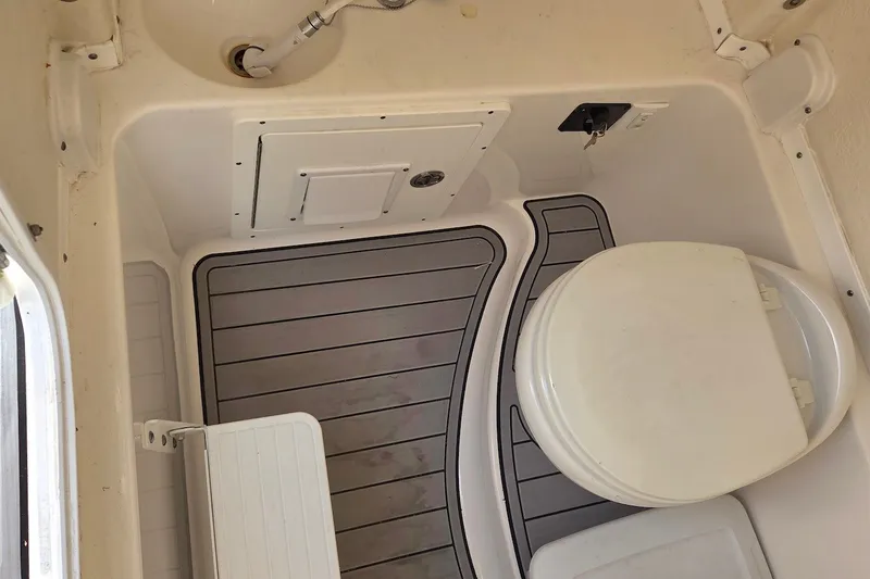Slide: The Image of 2022 Tidewater 282 CC Adventure boat interior with toilet and sink. - 21