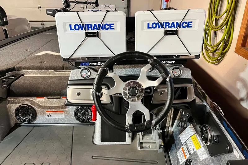 Slide: The Image of 2022 Nitro Z21 XL boat dashboard with dual Lowrance displays and steering wheel. - 13
