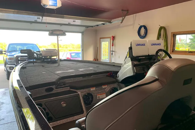 Slide: The Image of 2022 Nitro Z21 XL boat in garage with Lowrance electronics and truck outside. - 12