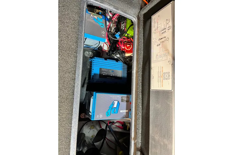 Slide: The Image of Storage compartment of a 2022 Nitro Z21 XL boat with electrical components and wiring. - 16