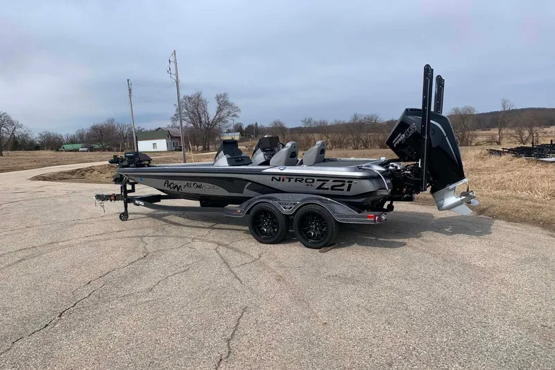 Slide: The Image of 2022 Nitro Z21 XL fishing boat on trailer in rural setting. - 5
