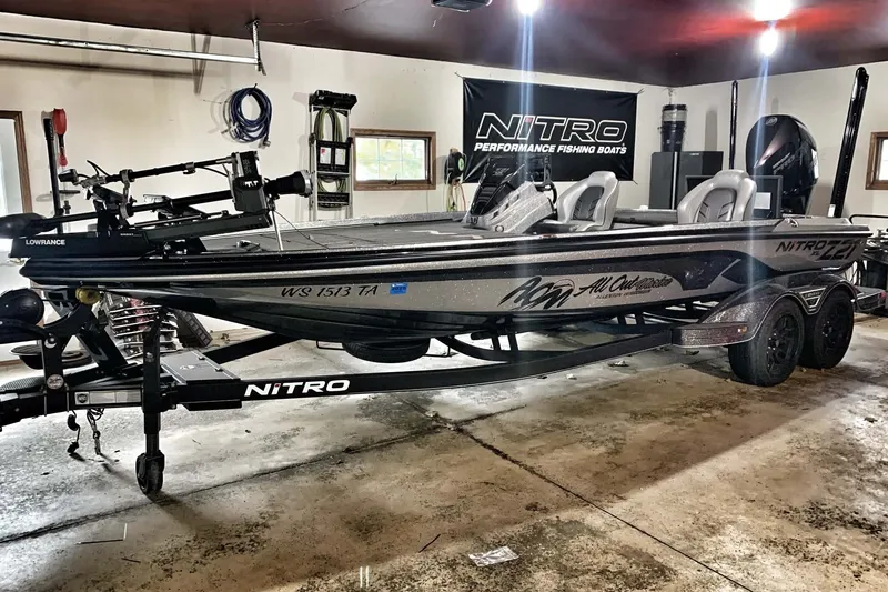 Slide: The Image of 2022 Nitro Z21 XL fishing boat in garage, featuring sleek design and advanced equipment. - 2