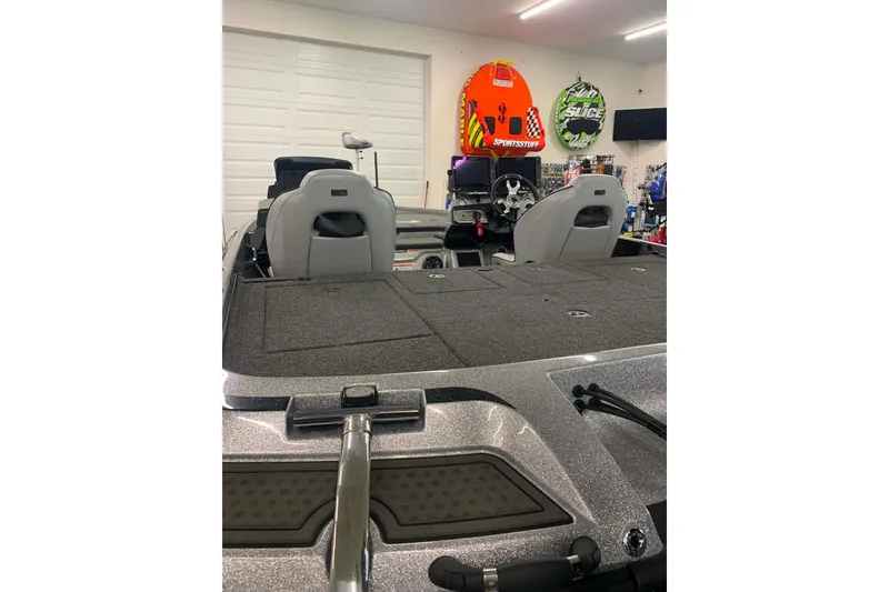 Slide: The Image of 2022 Nitro Z21 XL boat interior with seats and dashboard in a garage setting. - 14