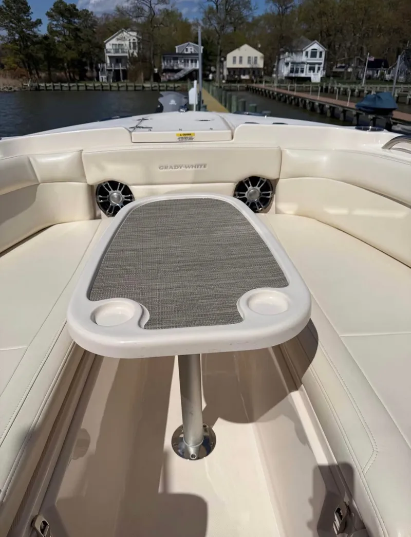 Slide: The Image of The image shows the bow area of a 2022 Grady-White Freedom 275 boat with a table. - 15