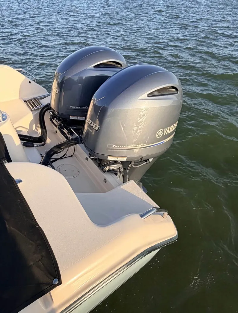 Slide: The Image of The image shows a 2022 Grady-White Freedom 275 with twin Yamaha outboard engines on the water. - 9