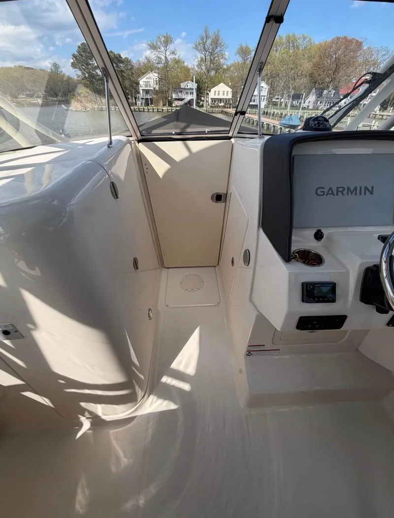 Slide: The Image of Interior view of a Grady-White Freedom 275 boat with helm and Garmin device. - 12