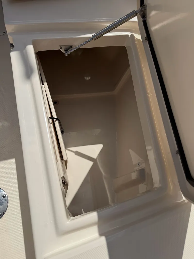 Slide: The Image of An open storage compartment on a 2022 Grady-White Freedom 275 boat. - 21