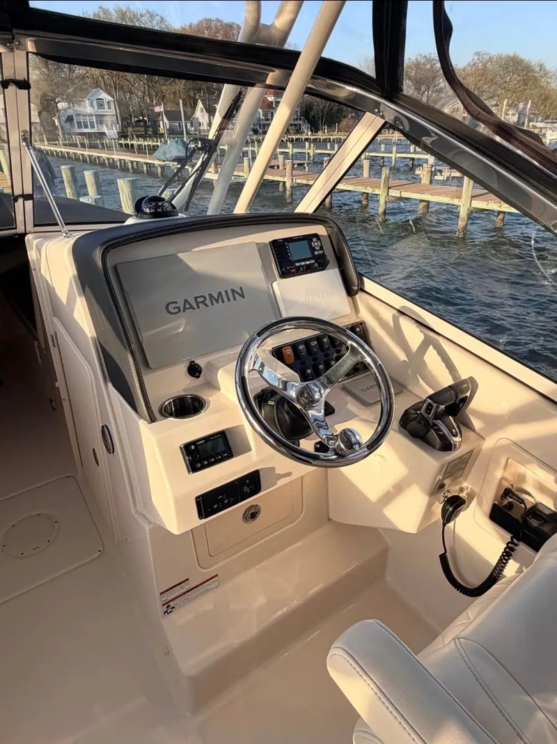Slide: The Image of The image shows the helm of a 2022 Grady-White Freedom 275 boat with Garmin equipment. - 4