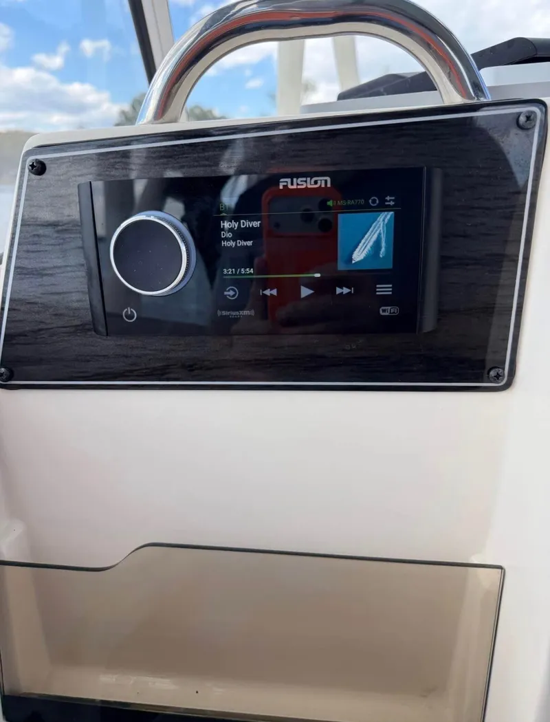 Slide: The Image of The image shows a Fusion audio system on a Grady-White Freedom 275 boat. - 10