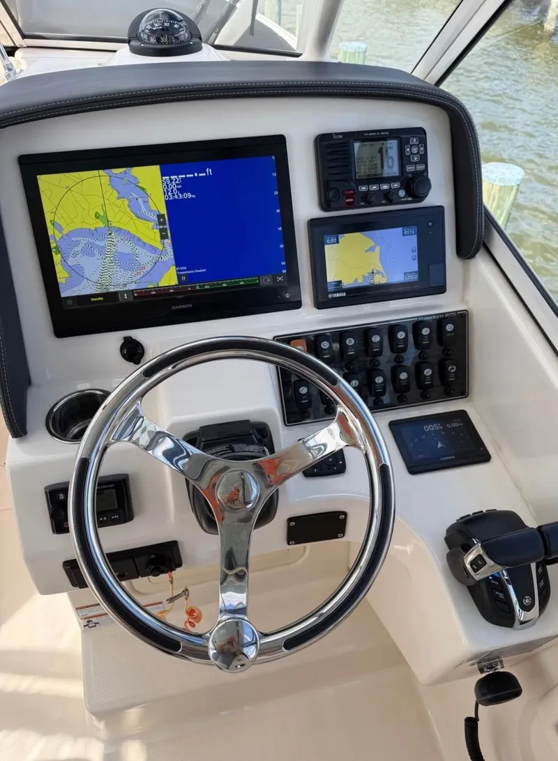 Slide: The Image of The image shows the helm of a 2022 Grady-White Freedom 275 boat with modern navigation equipment. - 5