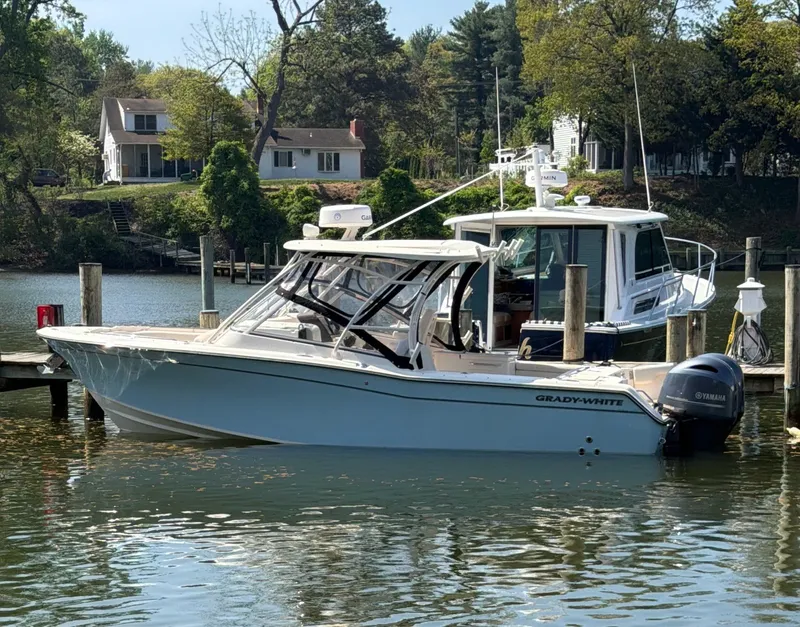 The Image of A 2022 Grady-White Freedom 275 boat docked at a serene pier. - 0