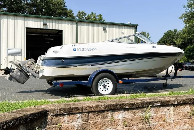 Slide: The Image of 1997 Four Winns 170 Horizon boat on trailer outside a warehouse. - 4