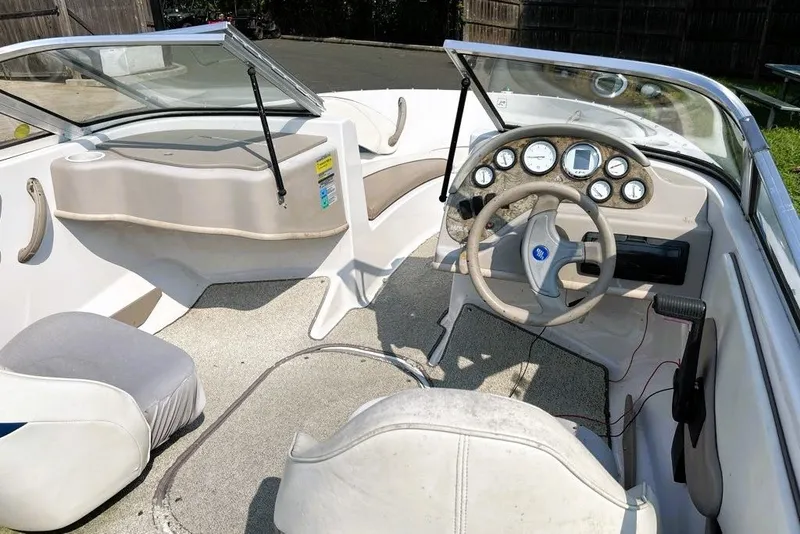 Slide: The Image of Interior of a 1997 Four Winns 170 Horizon boat, featuring steering wheel and dashboard. - 2