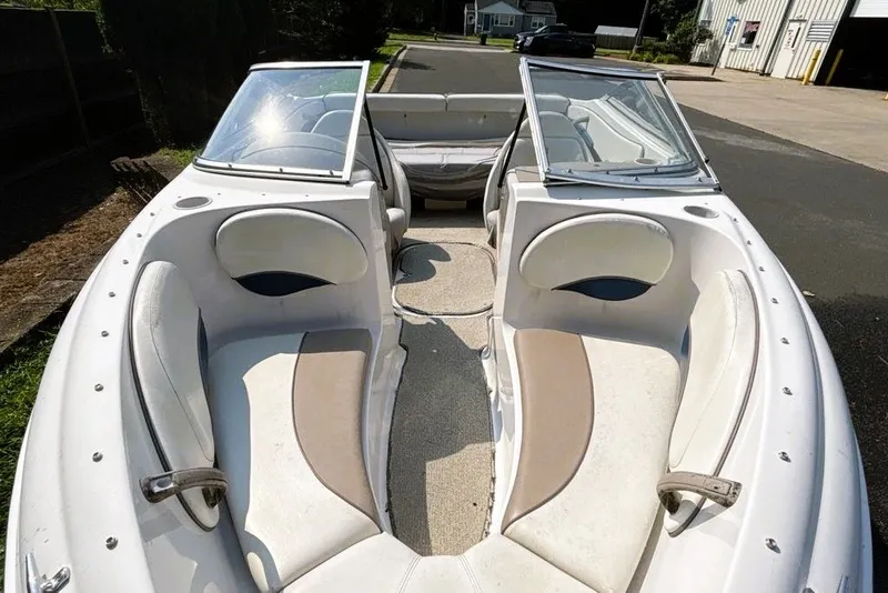 Slide: The Image of 1997 Four Winns 170 Horizon boat interior with white and beige seating. - 5