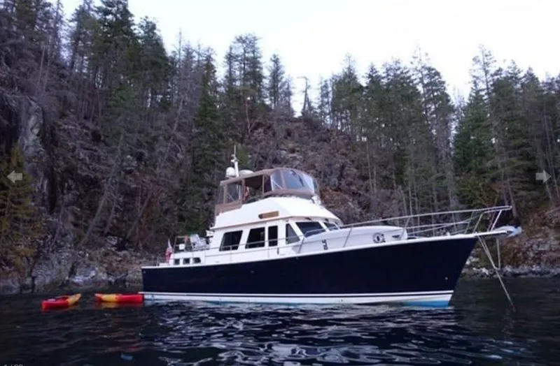 Slide: The Image of A 2000 Sabreline 47 is anchored in a wooded area. - 1