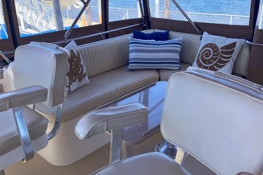 Slide: The Image of Interior of 2000 Sabreline 47 yacht with cushioned seating and decorative pillows. - 10