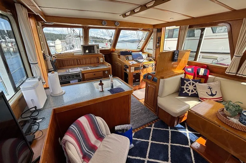 Slide: The Image of Interior of 2000 Sabreline 47 yacht with cozy seating and nautical decor. - 12