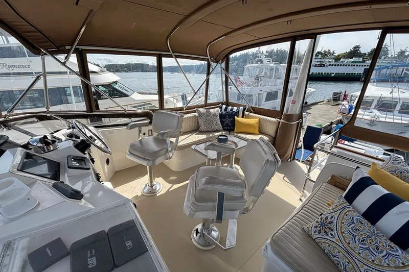 Slide: The Image of Interior view of 2000 Sabreline 47 yacht with seating and helm, docked at marina. - 11