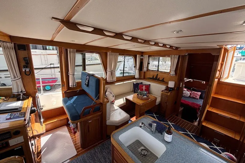 Slide: The Image of Interior of 2000 Sabreline 47 yacht with wood finish and cozy seating area. - 13