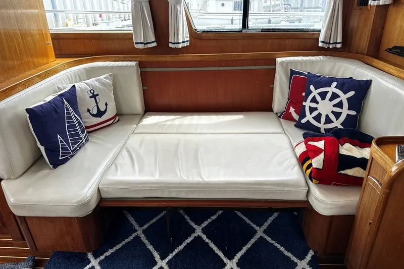 Slide: The Image of Cozy seating area on 2000 Sabreline 47 yacht with nautical-themed cushions and decor. - 14