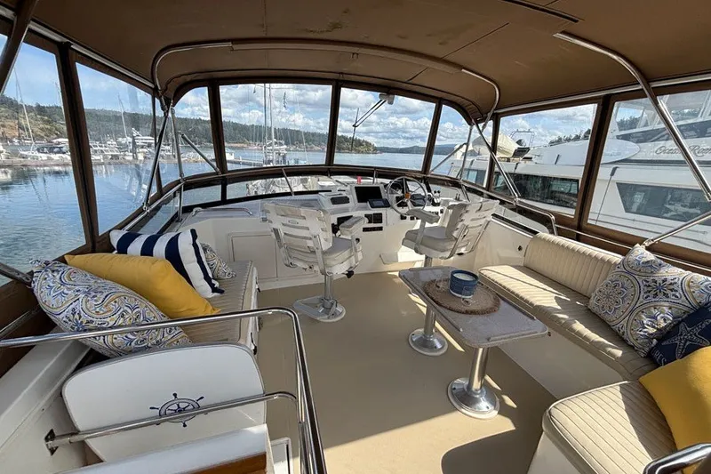 Slide: The Image of Luxurious 2000 Sabreline 47 yacht interior with plush seating and scenic marina view. - 5