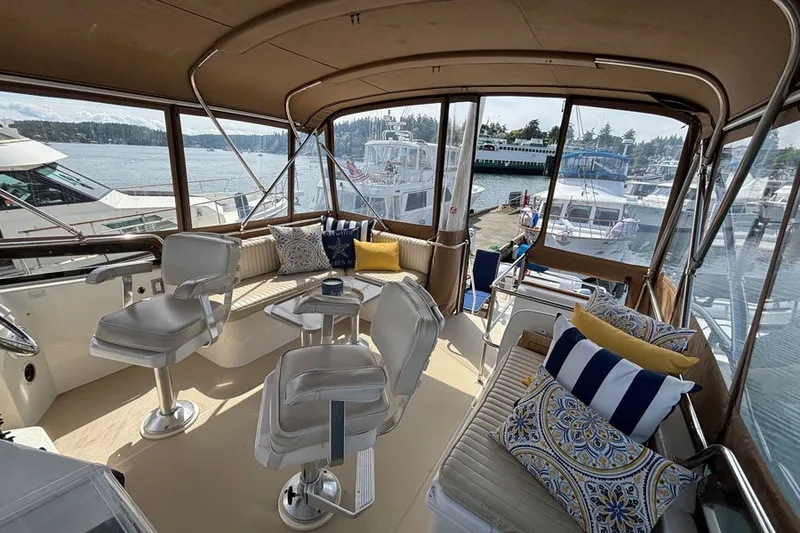Slide: The Image of Interior of a 2000 Sabreline 47 yacht with comfortable seating and scenic marina view. - 7