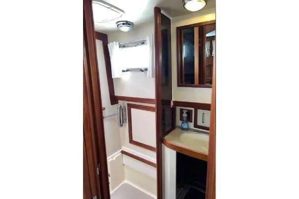 Slide: The Image of 2000 Sabreline 47 yacht bathroom with wood accents and compact design. - 30